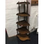 A mahogany corner whatnot with five graduated shaped shelves on spindle supports with turned