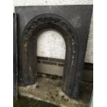A Victorian cast iron fire insert with arched foliate scrolled moulding. (29in x 35in)