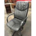 A modern office chair with upholstered back & seat having rounded arms, swivelling on an