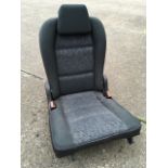 A substantial folding car seat, the upholstered chair with telescopic adjustable headrest.