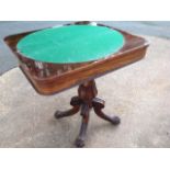 A George IV rosewood turn-over-top games table, with circular baize to interior, raised on carved