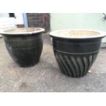 A pair of green glazed stoneware plant pots, with fluted gadroon style decoration. (2)