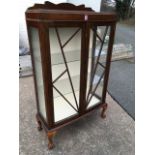 A bowfronted oak china cabinet with astragel glazed doors, raised on stub cabriole legs with