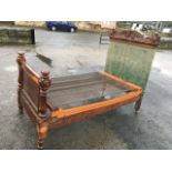 A Victorian bed with foliate scrolled carved crest to headboard framed by square cornerposts with