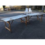 Two folding pine trestle style tables, on rectangular hinged legs - 4ft 6in & 5ft 10in. (2)