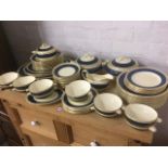An extensive Adderley dinner service decorated with goodes blue bands framed by scrolled gilding -