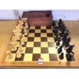 A chess set with dovetailed box, having inlaid hardwood board and Staunton pattern carved/turned