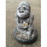 A composition stone garden gorilla ornament.