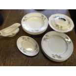 A Johnson Bros floral dinner service with plates, soup bowls, gravy boat, ashets, tureen & cover,