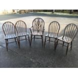 Four elm hooped spindleback chairs with solid seats raised on turned legs & stretchers; and a