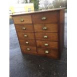 A mahogany chest of ten drawers, all mounted with brass cup handles, with rectangular rounded top.