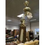 A brass ceiling light & fan, with five rotating blades above three lights with fluted glass shades.