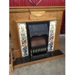 A reproduction pine fireplace, the surround with fluted pillars and frieze centred by an urn, with