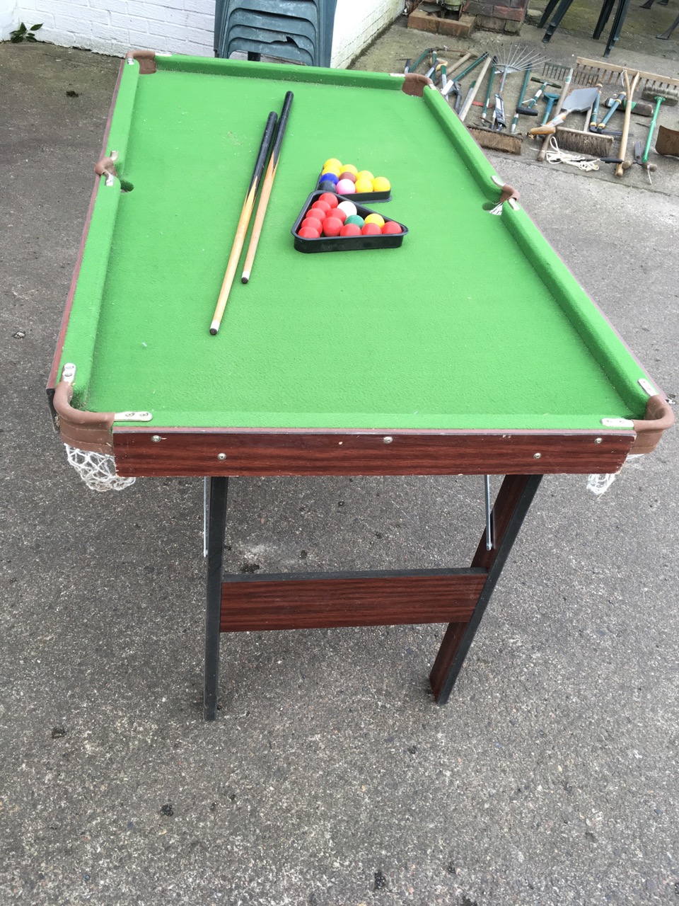 A folding pool table, the baize lined top with brass pockets, complete with cues, balls, triangle, - Image 3 of 3