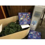 Two boxed artificial Christmas trees; and two boxed strings of Fiesta party lights, each with 10