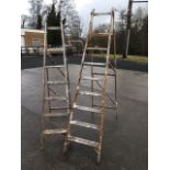 Two pairs of tall folding wood step ladders with ribbed treads and slatted work platforms. (2)