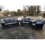 A leather three-piece suite, with three-seater and two-seater sofas and an armchair, all with