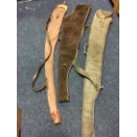 Two suede leather shotgun sleeves with lined interiors; and a third in canvas with leather mounts by