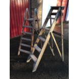 A pair of old wood steps with cast iron mounts and five treads; and another pair with slatted