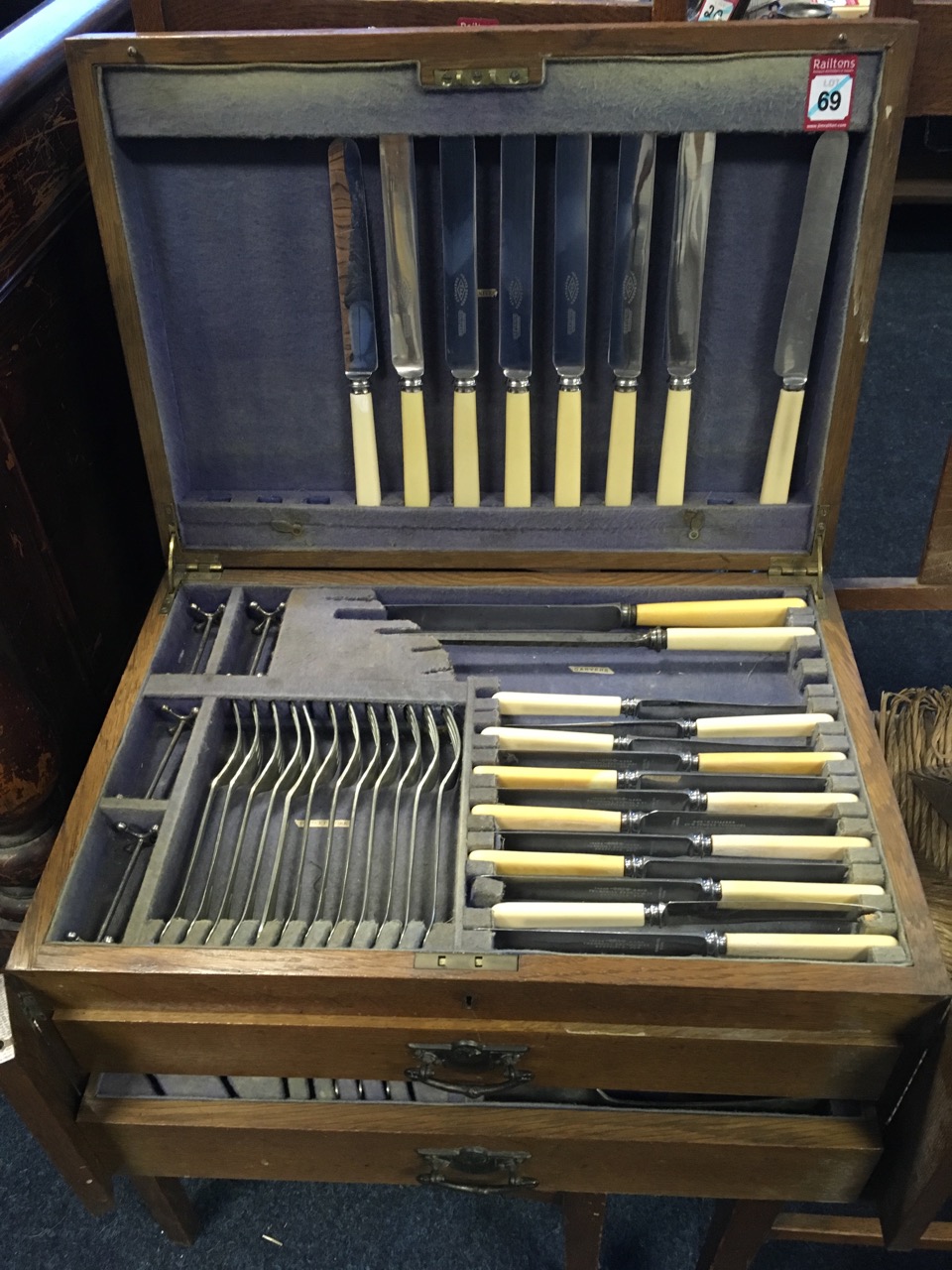 An oak cased Edwardian canteen of silver plated cutlery, the box with brass mounts containing two