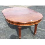 A Victorian walnut dining table with telescopic action and spare leaf, the moulded top supported