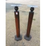 A pair of candlestands, the columns on lozenge moulded octagonal bases, with circular saucer tops on