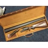 A cased 12 bore shotgun by CH Crawford of Birmingham, the side-by-side boxlock with walnut stock and