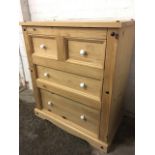 A pine chest of two short and two long panelled drawers mounted with knobs, the cabinet of bolted