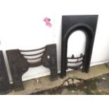 A cast iron Victorian fireplace front with bowfronted bars, the arch with lozenge mouldings; and a