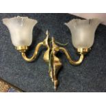 A pair of brass wall lights, with acid etched glass shades on scrolled brackets, the wall-plates