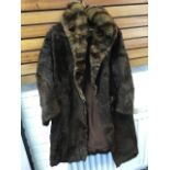 A lined mink fur coat with wide collar, by Lowe & Moorhouse Ltd.