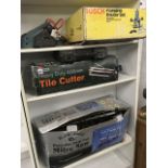 A boxed Black Forge deep cut mitre saw; a boxed Homebase tile cutter; a Black & Decker electric