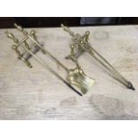 A set of brass fire irons with tubular shafts and baluster turned handles - poker, tongs & shovel;