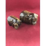 A graduated pair of tigers eye carved pigs. (5.5in & 4.25in) (2)