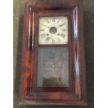 A Victorian American wallclock in rectangular cushion moulded mahogany case with glazed door, the