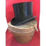 A leather cased silk top hat by Dunn & Co, the tapering box with brass mounts. (interior 6.5in x