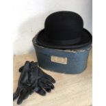 A boxed bowler hat by Leonards - size 7&1/8, together with a pair of black leather gloves.