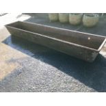 A rectangular 6ft cast iron trough with angles sides and moulded rim.