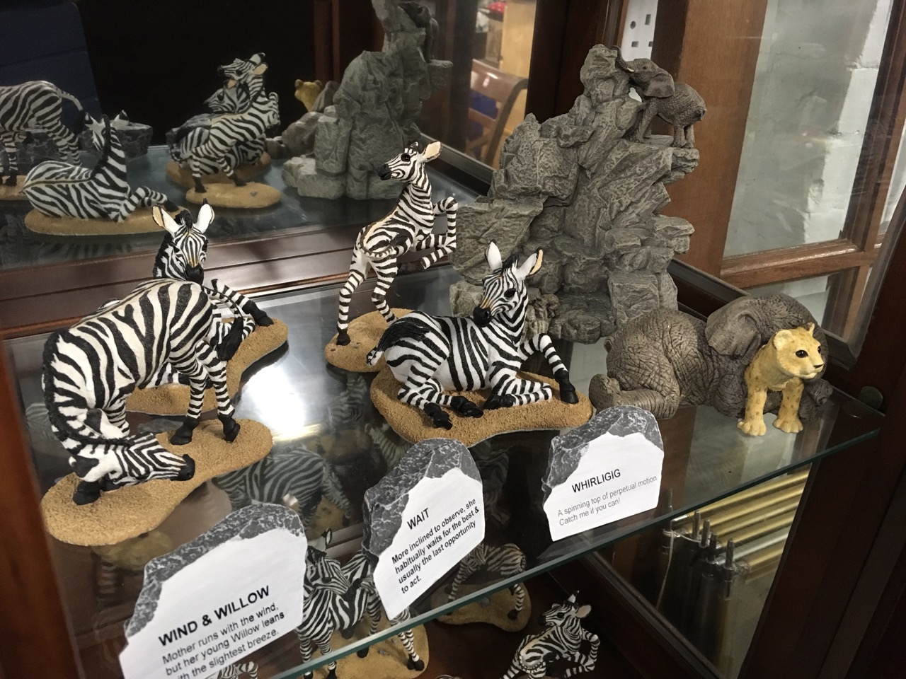 A collection of zebras with accompanying titles on faux rocks; a similar elephant and tiger model - Image 6 of 6