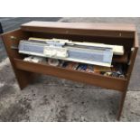 A Brother electric knitting machine with ribber, contained in a rectangular table cabinet,