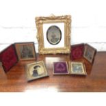 Four Victorian daguerreotype portrait photographs in leather frames with gilt metal mounts; and