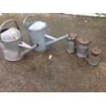 Two galvanised two gallon watering cans with angled spouts; and three metal cans & covers with swing