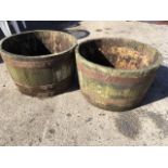 A pair of garden tubs of barrel form, the oak staves bound by three metal strap bands. (2)