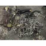 A quantity of horse bits including snaffle, rubber, D-ring, pelham, cheeck ring, etc; horse brasses,