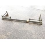 A telescopic brass fender, the moulded curb mounted with twisted rails supported by six dwarf