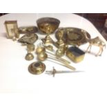 Miscellaneous brass including a pair of candlesticks, animal ornaments, ladels, bells, a bowl,