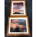 A pair of contemporary framed sunset photographs. (2)