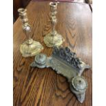 A pair of rococo ormolu brass candlesticks cast with scrolled decoration; and a brass desk stand