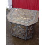 A brass coal or log box with angled lid, embossed with classical figural scenes framed by foliate