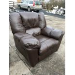 A large leather upholstered armchair, the reclining seat with integral footrest, raised on casters.